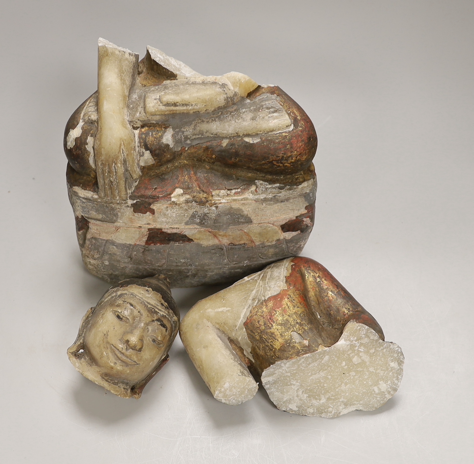 A 19th century Burmese painted alabaster figure of Buddha, damaged, 38cm